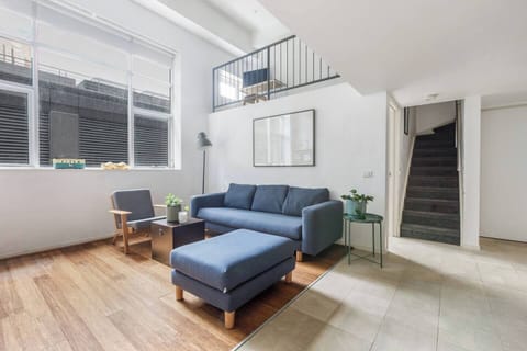 High ceilings and large windows create an industrial vibe in this apartment.