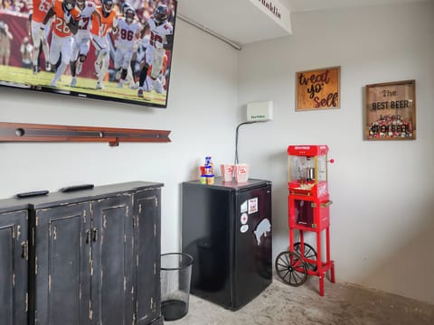 There’s a popcorn machine and a mini fridge for ultimate Game Night snacks.