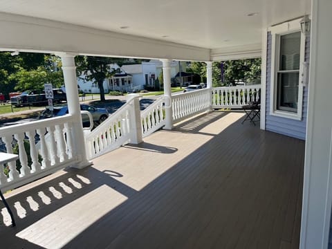 Large wrap-around porch with wicker furniture in the season