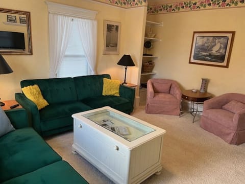 Living room with 2 click-clack sofas and sleep sacks.