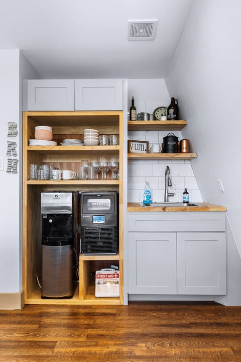 Fully stocked coffee and beverage station with sink.