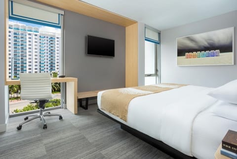 Drift off beneath modern lighting in a calming, airy room.