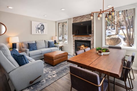 This beautiful living room has thoughtfully chosen modern furnishings, a gas fireplace and large windows creating an inviting space to unwind.