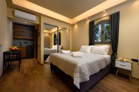 Bedroom with queen size bed, TV and wardrobe