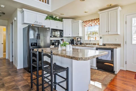 Fully stocked and ready for your culinary creations, this bright kitchen features modern appliances, a large island, and plenty of seating for entertaining! "Lake House"