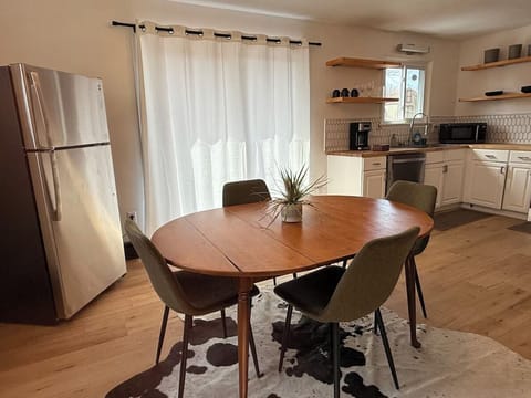 Mid century modern dining room with full size fridge and 2025 kitchen.