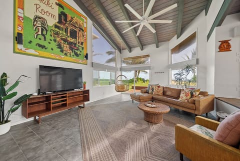 Bright and airy living space with vaulted ceiling and coastal decor, perfect for relaxing after a day at the beach.