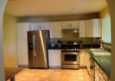 Kitchen with full size refrigerator, gas stove, oven, dishwasher, microwave