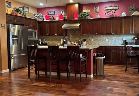Three stools at the granite countertop island