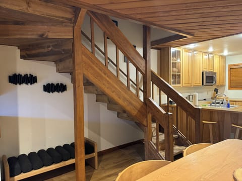 Bench and coatracks under stairs for convenient storage