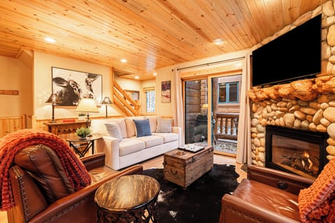 Main Living Space with Queen Sofa Sleeper, Gas Fireplace, TV, & Patio Access