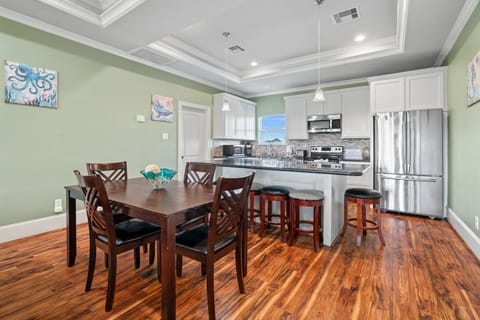 Dining table, additional seating at the kitchen island counter.