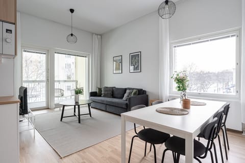 The open-plan layout creates a bright, social space perfect for relaxing together after a day of exploring Tampere. You`ll find plenty of natural light and direct access to the glazed balcony from here.
