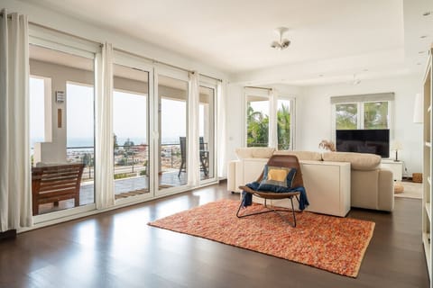 Bright and spacious living area with panoramic sea views – the perfect spot to unwind with family and friends.