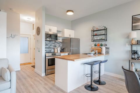 Kitchen with bar seating for 2 and dining table with seating for 4