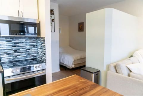 Bedroom nook just off of kitchen. Queen bed in cozy bedroom. Not fully isolated from living area.