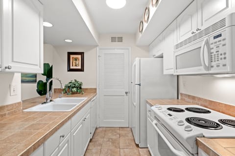 A convenient laundry room right off the kitchen allows easy access and washing and drying clothes efficiently.