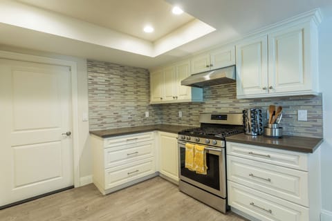 Fully stocked kitchen with gas stove and oven.