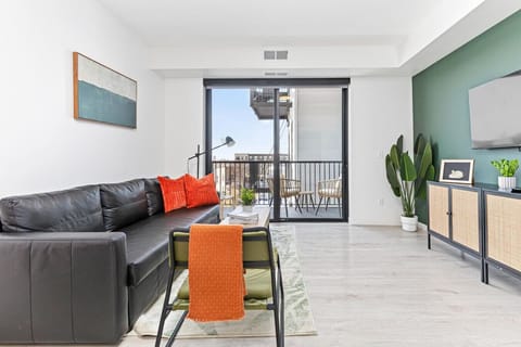 The living room is filled with natural light, creating a bright and welcoming space that invites relaxation.