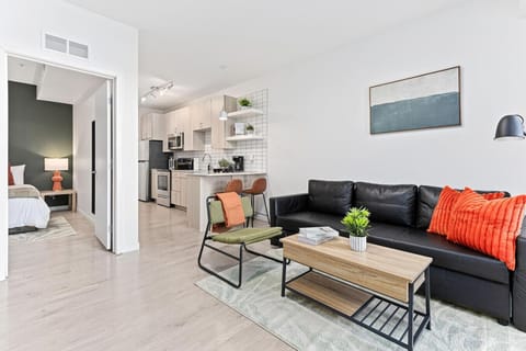The living room is filled with natural light, creating a bright and welcoming space that invites relaxation.