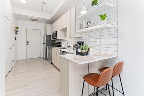 As you approach the home bar, the elegant layout and well-stocked shelves make it the ideal spot to relax.
