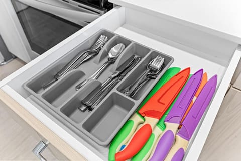 Kitchen cabinets stocked with cooking wares, glassware and silverwares, ideal for mixing up your favorite meals and drinks during your stay.