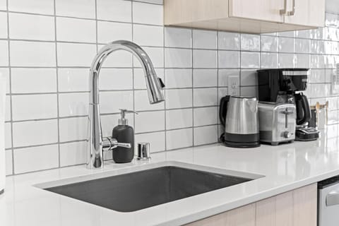 Kitchen cabinets stocked with cooking wares, glassware and silverwares, ideal for mixing up your favorite meals and drinks during your stay.