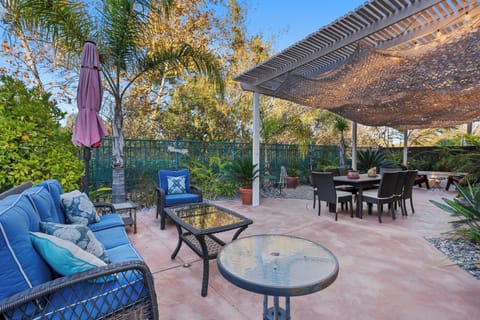 Outdoor seating, another seating around a dining table, BBQ, and a fireplace