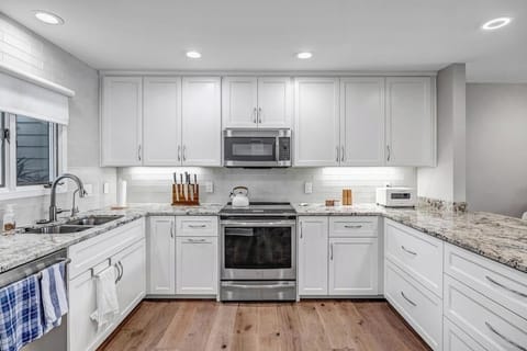- Cook up delicious meals in this bright, fully equipped kitchen with sleek granite counters
- Enjoy extra cabinetry, a modern stainless steel range, and soft under cabinet lighting
- Clean, practical setup for anything from snacks to feasts