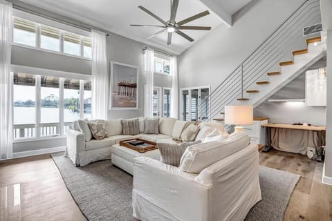 - Relax in this stunning lakeview living space with large sectional and desk nook
- Soaring ceilings, open staircase, and picture windows offer a dramatic flair
- Perfect mix of comfort, light, and elegant modern design