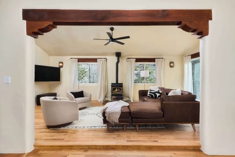 Upstairs living room. Gas fireplace. Timber framing and wood floors. 
