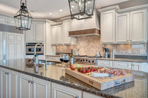 Well equipped kitchen with 10’ island featuring sink, dishwasher & wine fridge.
