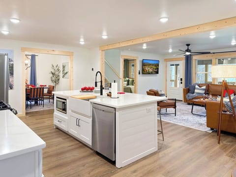 There's a large kitchen island with a sink and faucet.