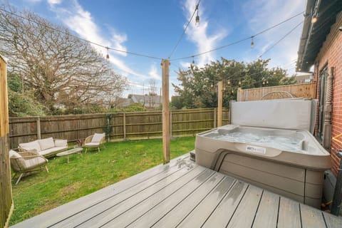 Inviting hot tub set in a quiet corner of the garden, perfect for unwinding in privacy.