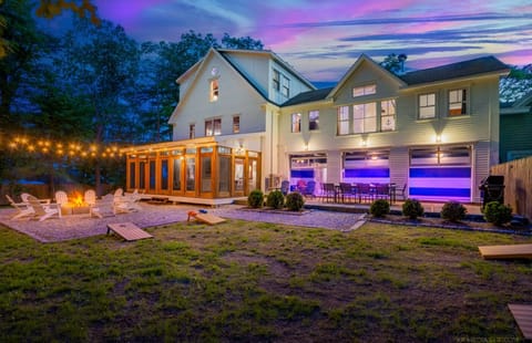 Beautiful backyard with fire pit, string lights, and a bright screened porch.