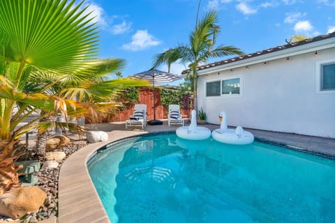 Enjoy your private oasis with a sparkling pool, swaying palms, and sunny skies. Lounge, float, or relax in this perfect outdoor retreat.