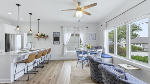 Open-concept dining room with comfortable seating positioned to overlook the lake, offering a relaxed setting for meals with a view.