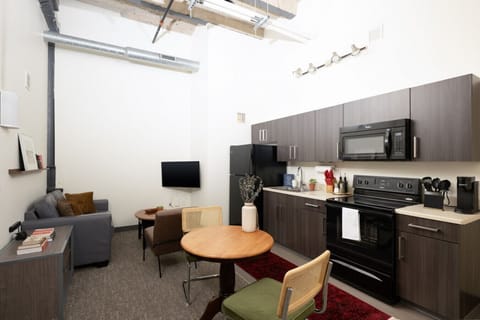 Living room with soaring ceilings, seating areas, and dining/work table