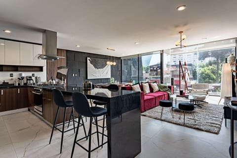 Modern kitchen and breakfast bar just steps from the cozy living area