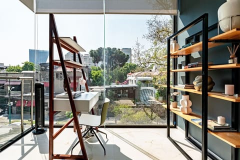 Floor-to-ceiling windows bring in light and a serene outdoor view from the lounge
