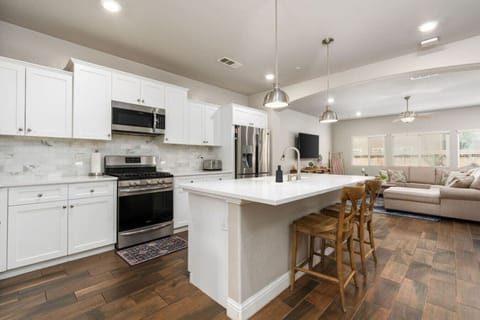 Modern Kitchen Island with Stools! Gather around the sleek granite island, complete with stylish stools, for casual meals, morning coffee, or great conversations. A perfect spot for relaxing and enjoying the heart of the kitchen.