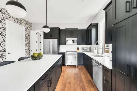 With plenty of space to move around, this open-concept kitchen is perfect for cooking, complete with stainless steel appliances and ample counter space.
