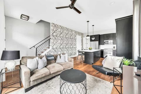 Enjoy the ample space and natural light in this living room, featuring a comfortable sofa bed for additional sleeping capacity and a stylish, welcoming design.

