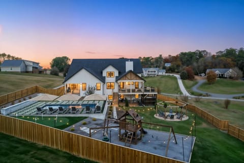 Pull up to the whole estate glowing at dusk — pool lit, fire pit waiting, mountains behind. The moment your group realizes this weekend is going to be unforgettable.