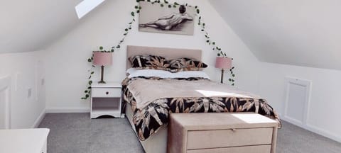 Spacious loft room approached by second flight of stairs.