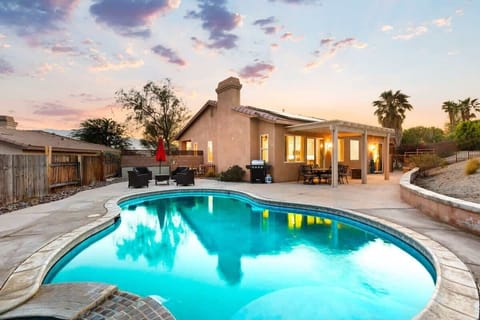 Unwind poolside surrounded by golden desert skies