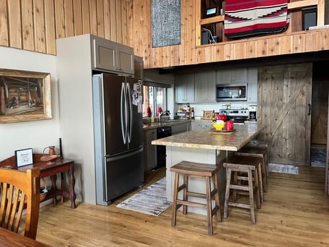 Full kitchen with large fridge, oven and range, microwave, and dishwasher!