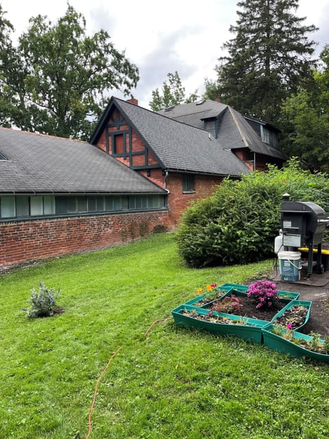 The backyard is private and green with parking and patio/grill in tow.