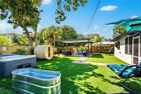 A tropical paradise with lush greenery and cozy seating areas.