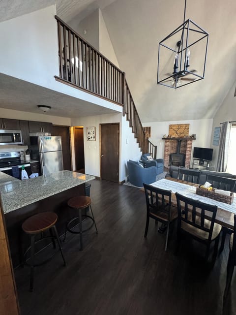 Kitchen, dining area and living room. Stairs to loft.